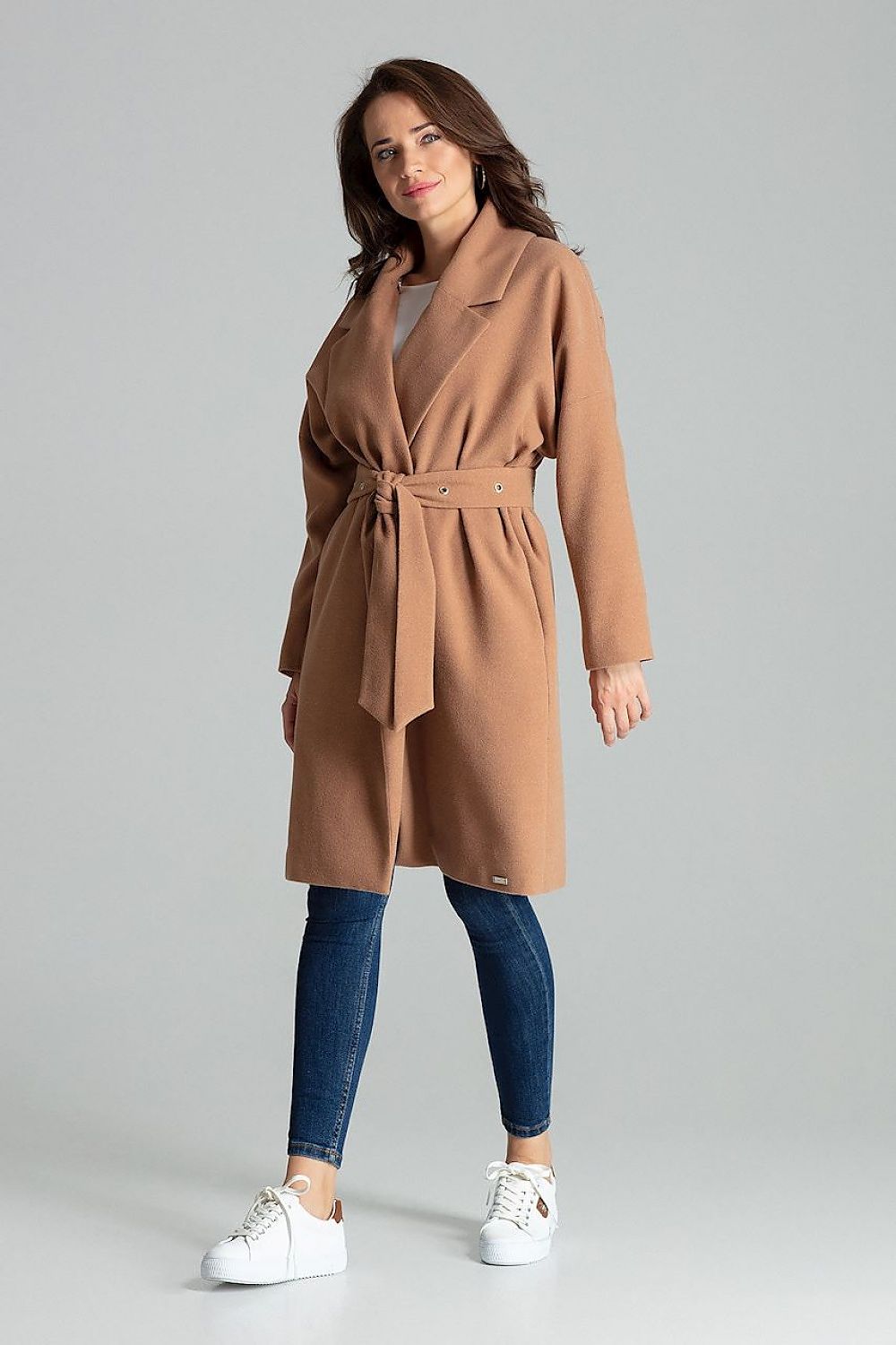 Model wearing a Carivelle maroon belted coat with wide lapels, featuring metal eyelets and side-seam pockets.