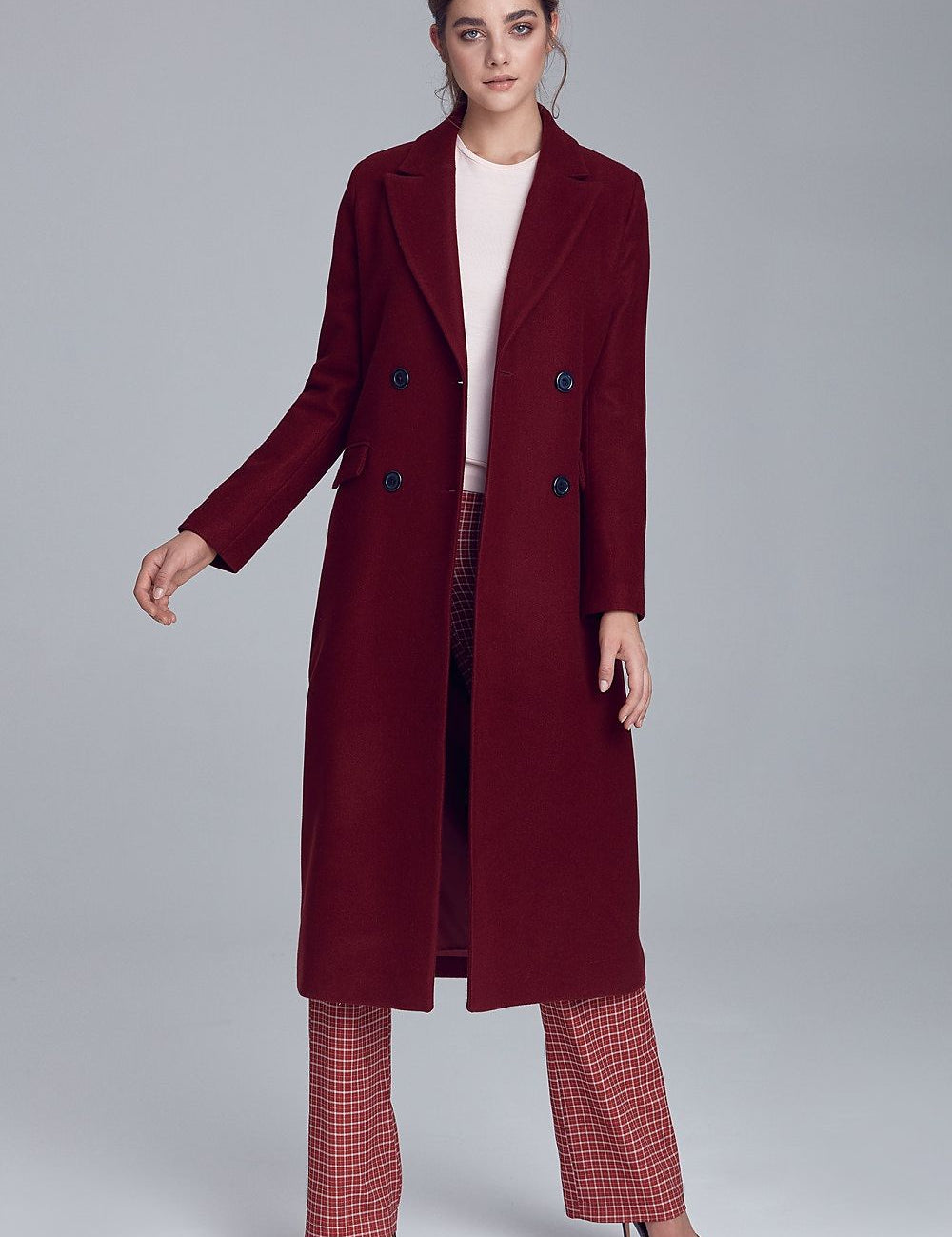 Woman wearing Marcelaine long double-breasted wool-blend coat in burgundy, showcasing elegant autumn fashion.