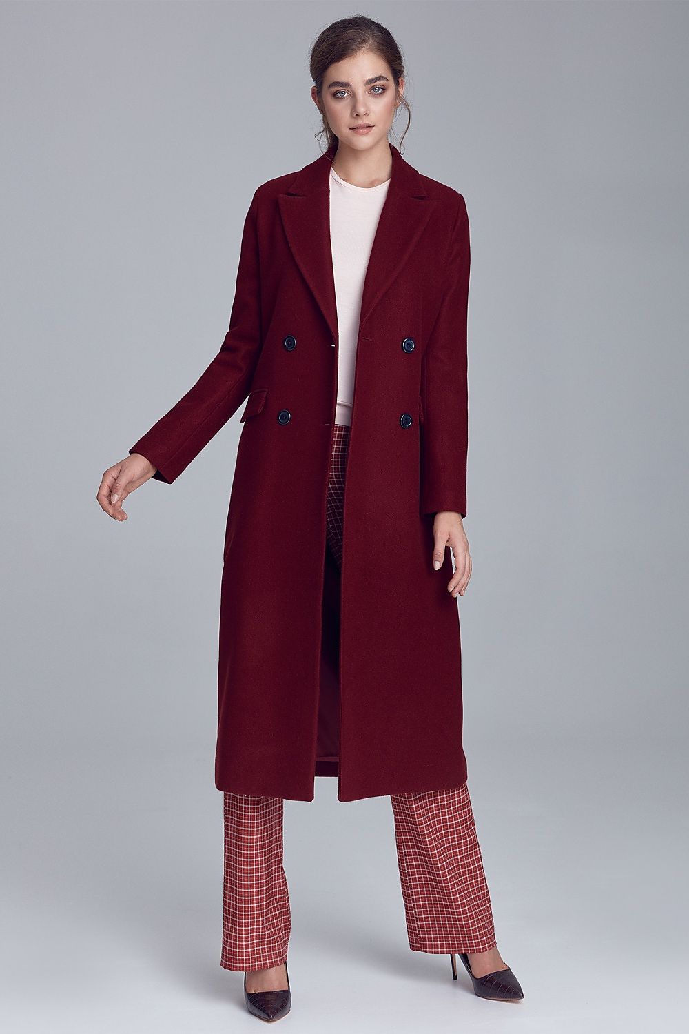 Woman wearing Marcelaine long double-breasted wool-blend coat in burgundy, showcasing elegant autumn fashion.