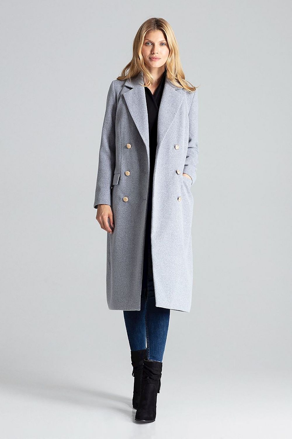 Woman wearing Vernadell gray double-breasted coat with gold buttons, tailored collar, and patch pockets. Elegant winter fashion.