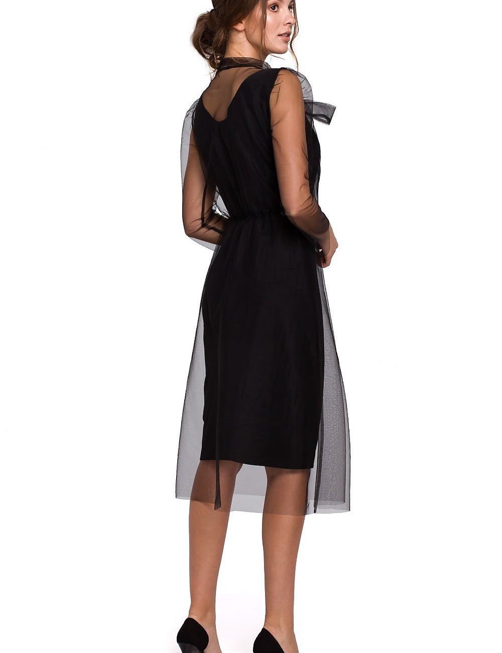 Side view of a woman wearing a black Ferelith Tulle Collar Midi Dress with sheer overlay and high heels.