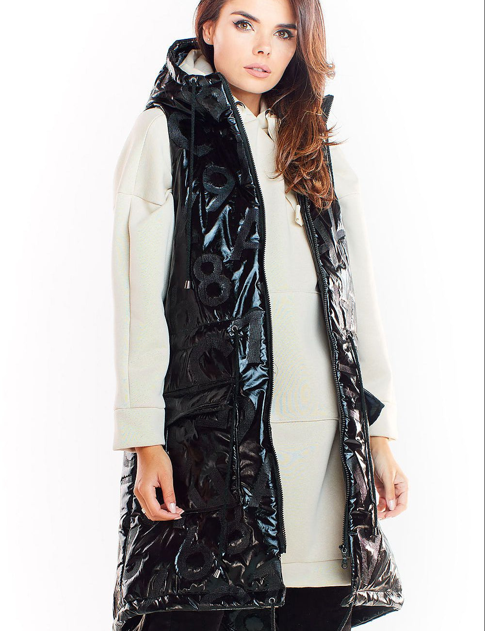 Woman wearing Orlavine Shiny Quilted Hooded Gilet Vest in black and silver tones with hood and pockets