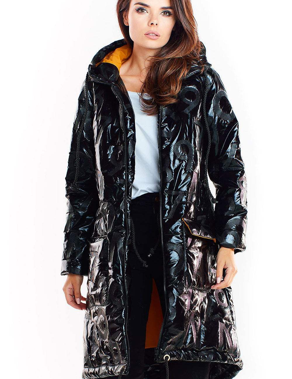 Woman wearing Morvanna oversized glossy insulated coat in black with contrasting lining, showcasing urban layering fashion.