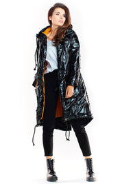 Woman wearing Morvanna oversized glossy insulated coat with contrasting lining, styled for urban layering, deep black finish.