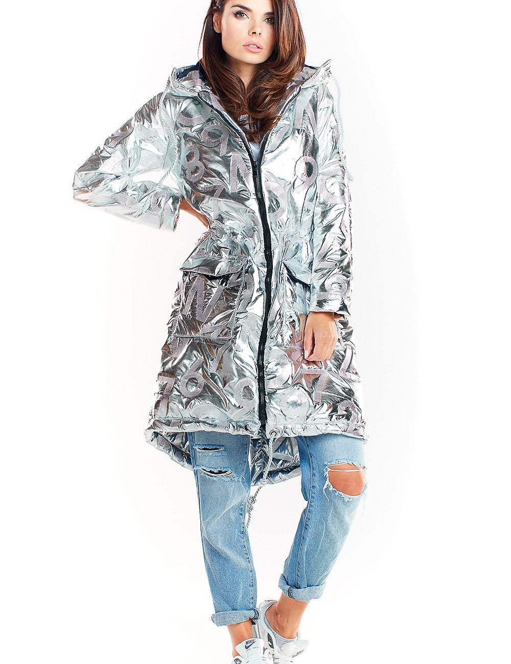 Model wearing Morvanna Oversized Glossy Insulated Coat in silver, styled with ripped jeans and sneakers, showcasing urban chic fashion.