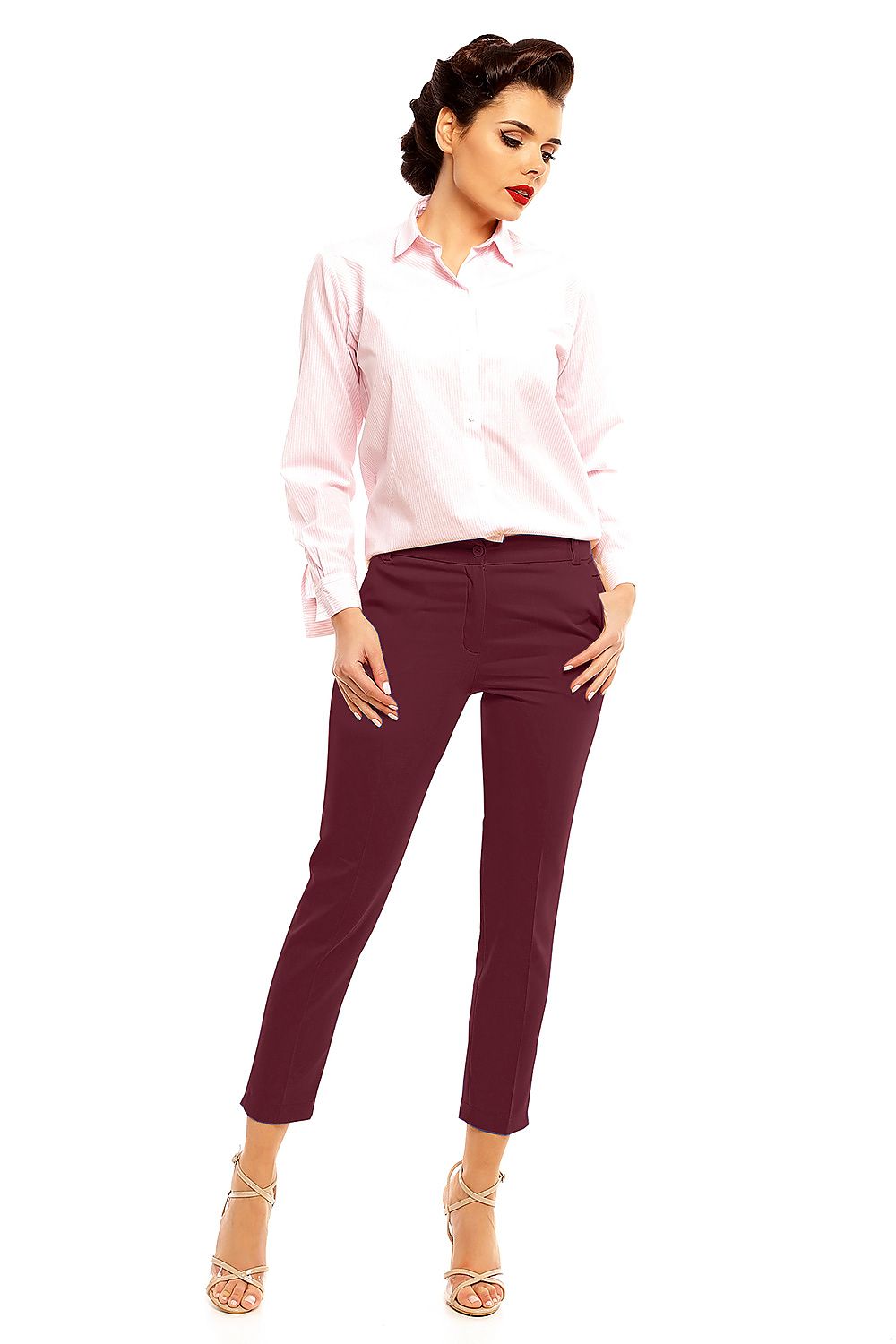 Fashion model wearing Plus Size Marvielle High-Waist 7/8 Trousers paired with a pink shirt and heels, showcasing elegant style.
