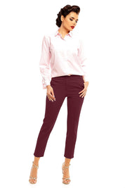 Fashion model wearing Plus Size Marvielle High-Waist 7/8 Trousers paired with a pink shirt and heels, showcasing elegant style.