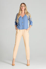 Woman wearing Ermeya Buttoned Blue Blouse with beige pants, featuring bateau neckline and three-quarter sleeves.