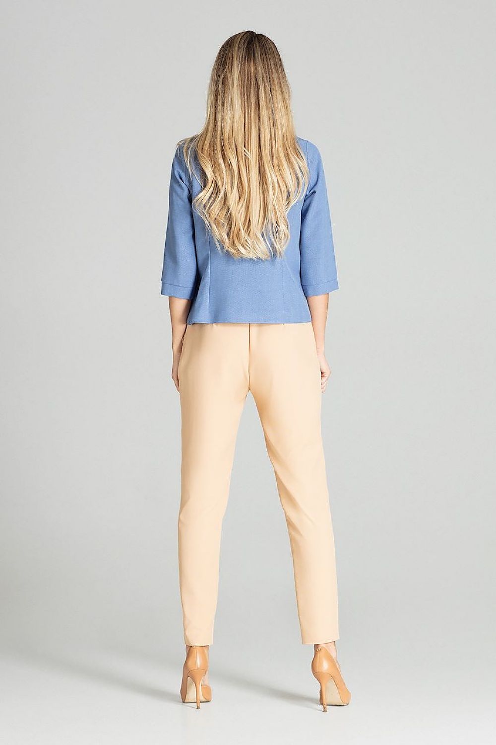 Back view of model wearing Ermeya Buttoned Blue Blouse with bateau neckline and three-quarter sleeves, paired with beige trousers.