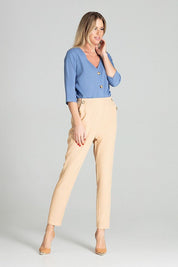 Woman wearing Ermeya Buttoned Blue Blouse with bateau neckline and three-button closure, styled with beige trousers.