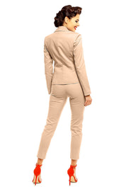 Woman wearing beige Marvielle high-waist 7/8 plus size trousers, styled with red heels, showcasing elegant and tailored fit.