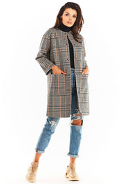 Woman wearing Calverisse Checked Straight-Cut Coat, no collar, navy blue and brown check pattern, with ripped jeans and boots.
