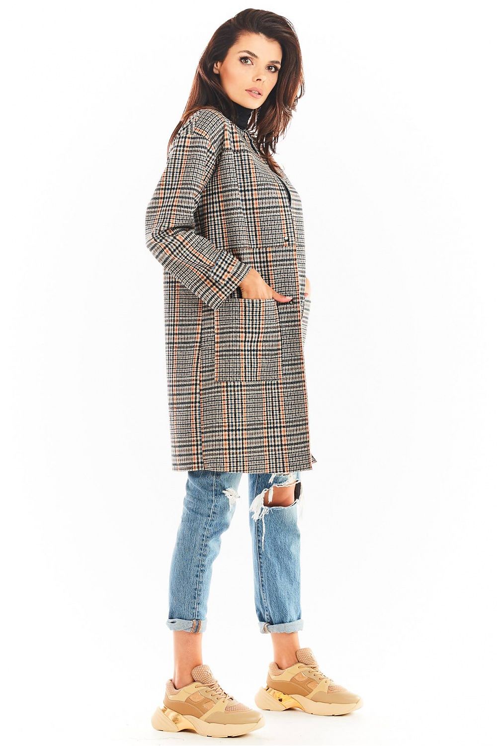 Woman wearing a Calverisse Checked Straight-Cut Coat in navy blue and brown, styled with jeans and sneakers.