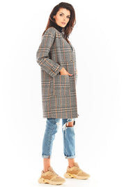 Woman wearing a Calverisse Checked Straight-Cut Coat in navy blue and brown, styled with jeans and sneakers.