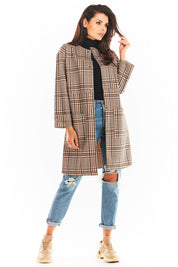 Model wearing Calverisse Checked Straight-Cut Coat in brown, featuring a modern collarless design, paired with jeans and sneakers.