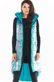 Woman wearing Lumarelle holographic hooded gilet vest, shimmering blue finish with large hood and pockets, stylish and warm autumn wear.