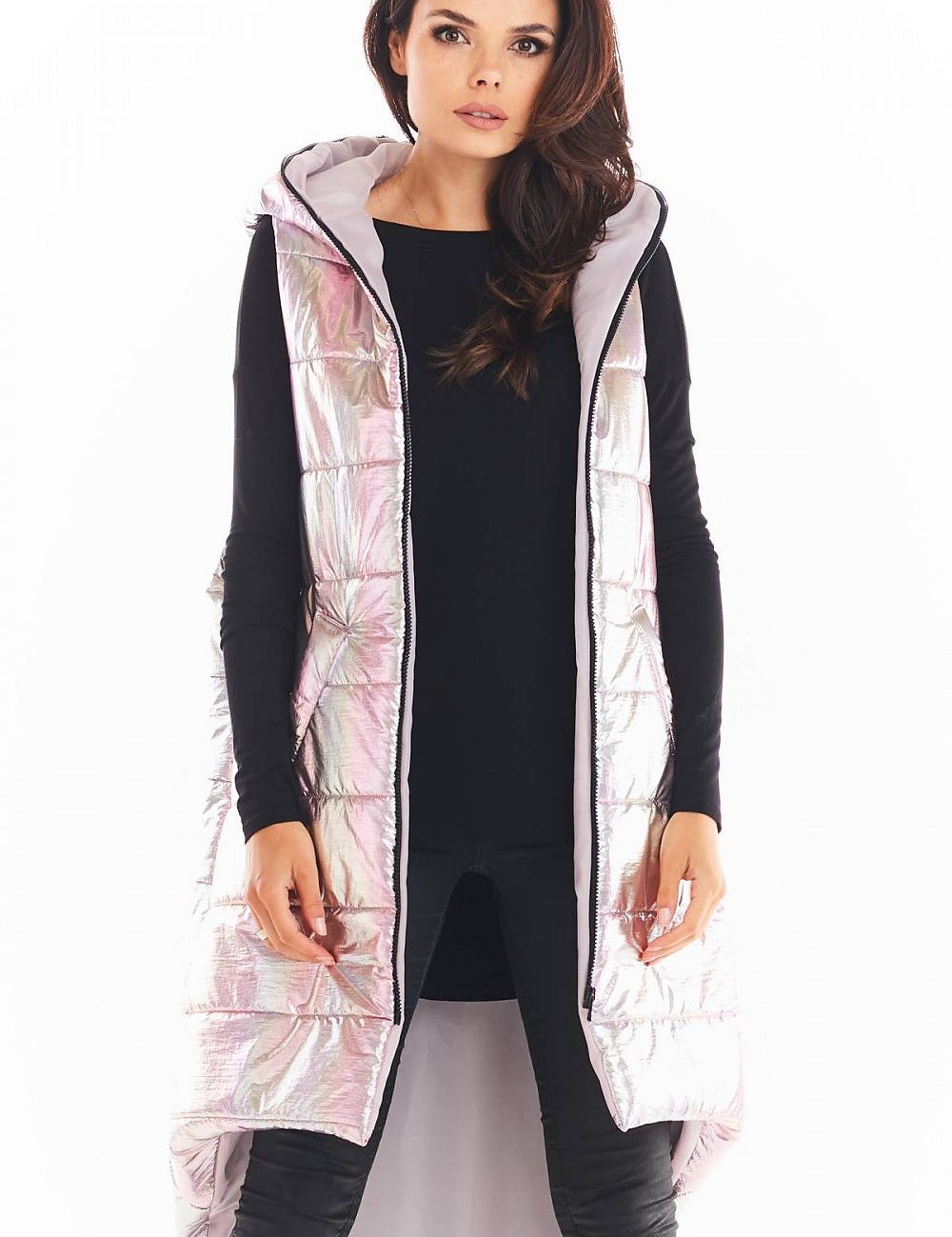 Lumarelle Holographic Hooded Gilet Vest in pink with shimmering finish, extended back, and spacious front pockets, worn over black outfit.