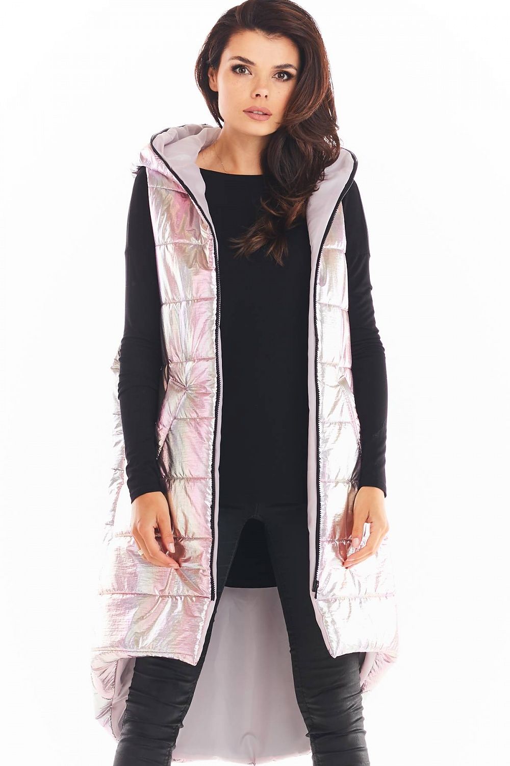 Lumarelle Holographic Hooded Gilet Vest in pink with shimmering finish, extended back, and spacious front pockets, worn over black outfit.