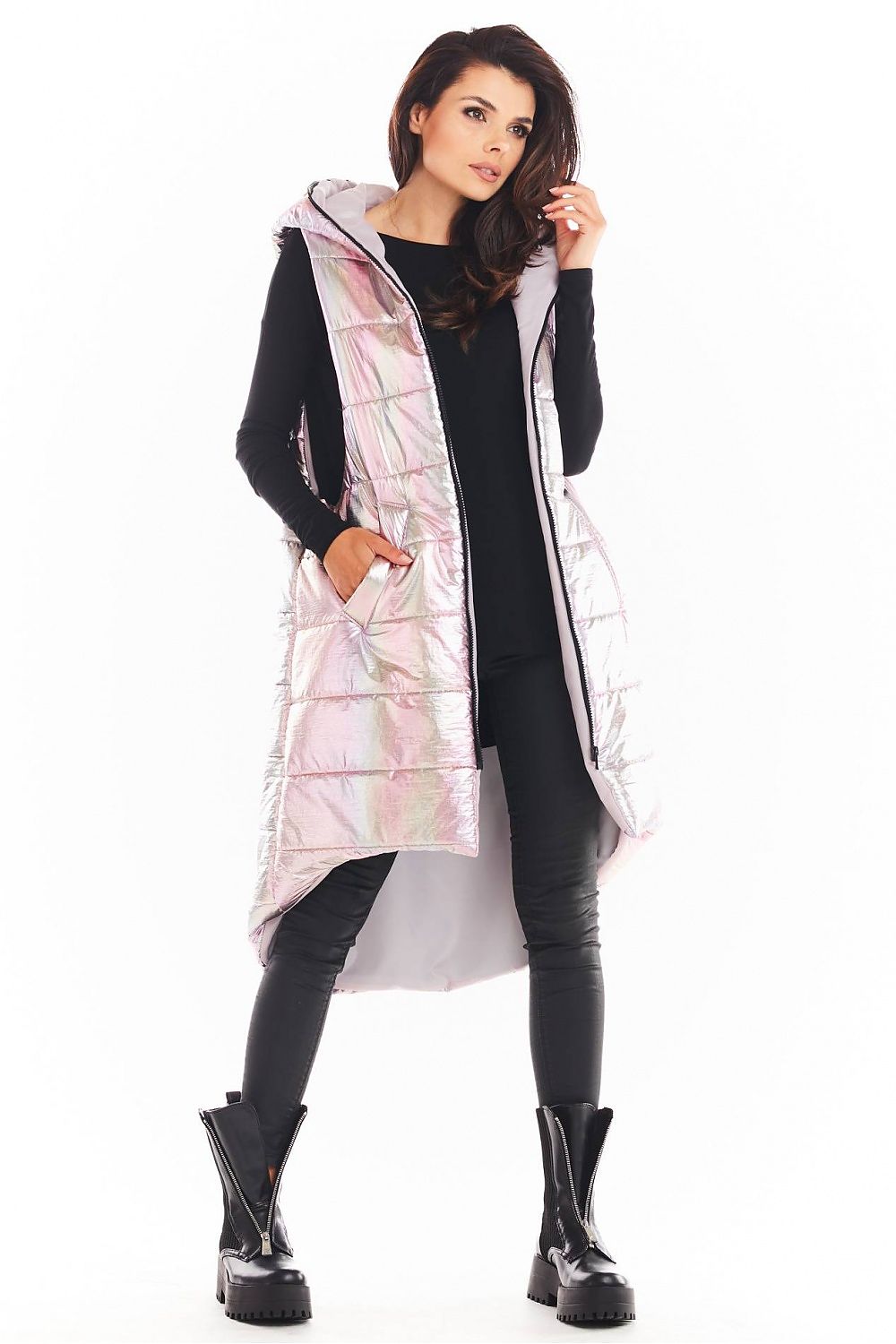 Woman wearing Lumarelle Holographic Hooded Gilet Vest in pink, showing its long silhouette, large pockets, and shiny finish.