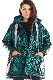 Amawa oversized quilted hooded jacket with decorative logo tape, featuring front pockets and snap fastening, worn by a model.