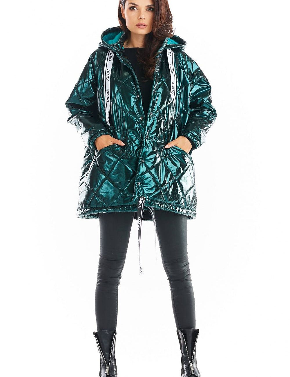 Model wearing Amawa Oversized Quilted Hooded Jacket with large hood and front pockets, styled with decorative logo tape.