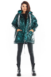 Model wearing Amawa Oversized Quilted Hooded Jacket with large hood and front pockets, styled with decorative logo tape.