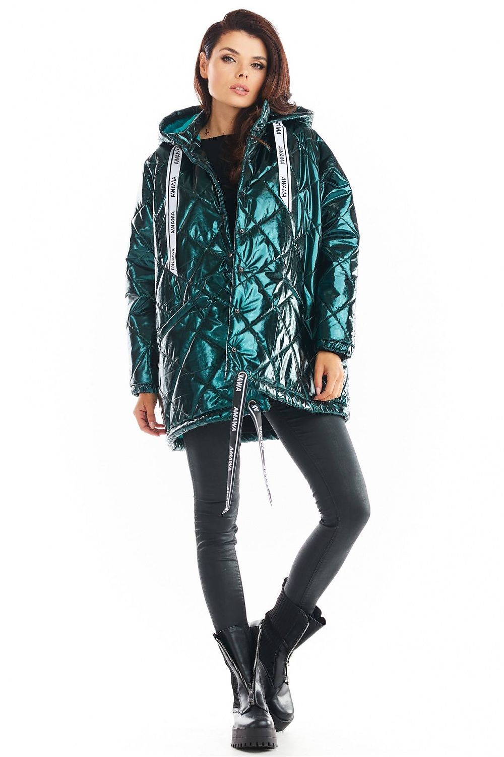 Woman wearing Amawa oversized quilted hooded jacket with decorative logo tape, showcasing modern style and versatility with front pockets.