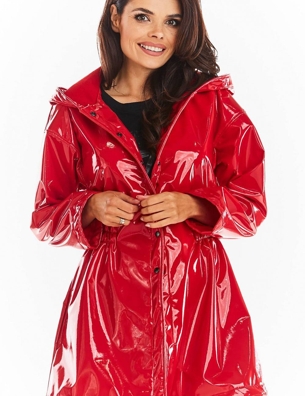 Model wearing red Orlavenne knee-length vinyl hooded coat with buttons, flared hem, and drawstring waist.