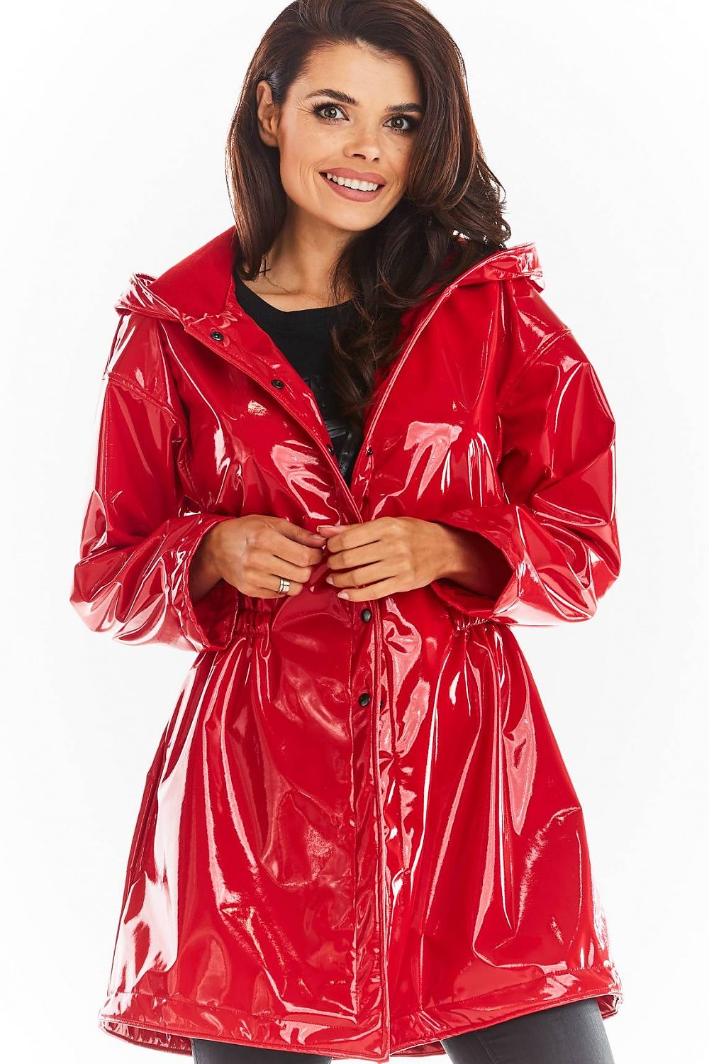 Model wearing red Orlavenne knee-length vinyl hooded coat with buttons, flared hem, and drawstring waist.