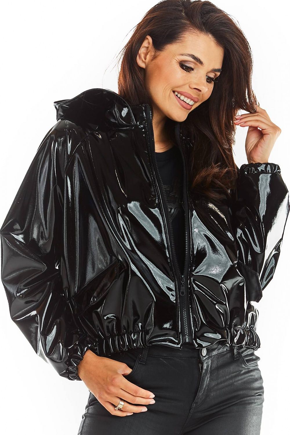 Woman wearing black Nerivelle short vinyl hooded jacket with ribbed cuffs and zip front, showcasing street style and practicality.