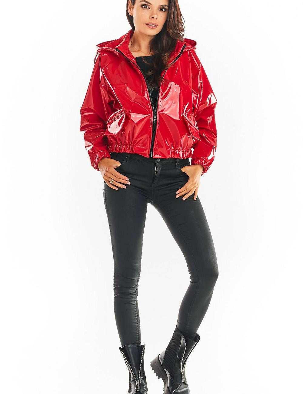 Red Nerivelle short vinyl hooded jacket with ribbed cuffs and zip front, paired with black pants and boots, showcasing street style fashion.