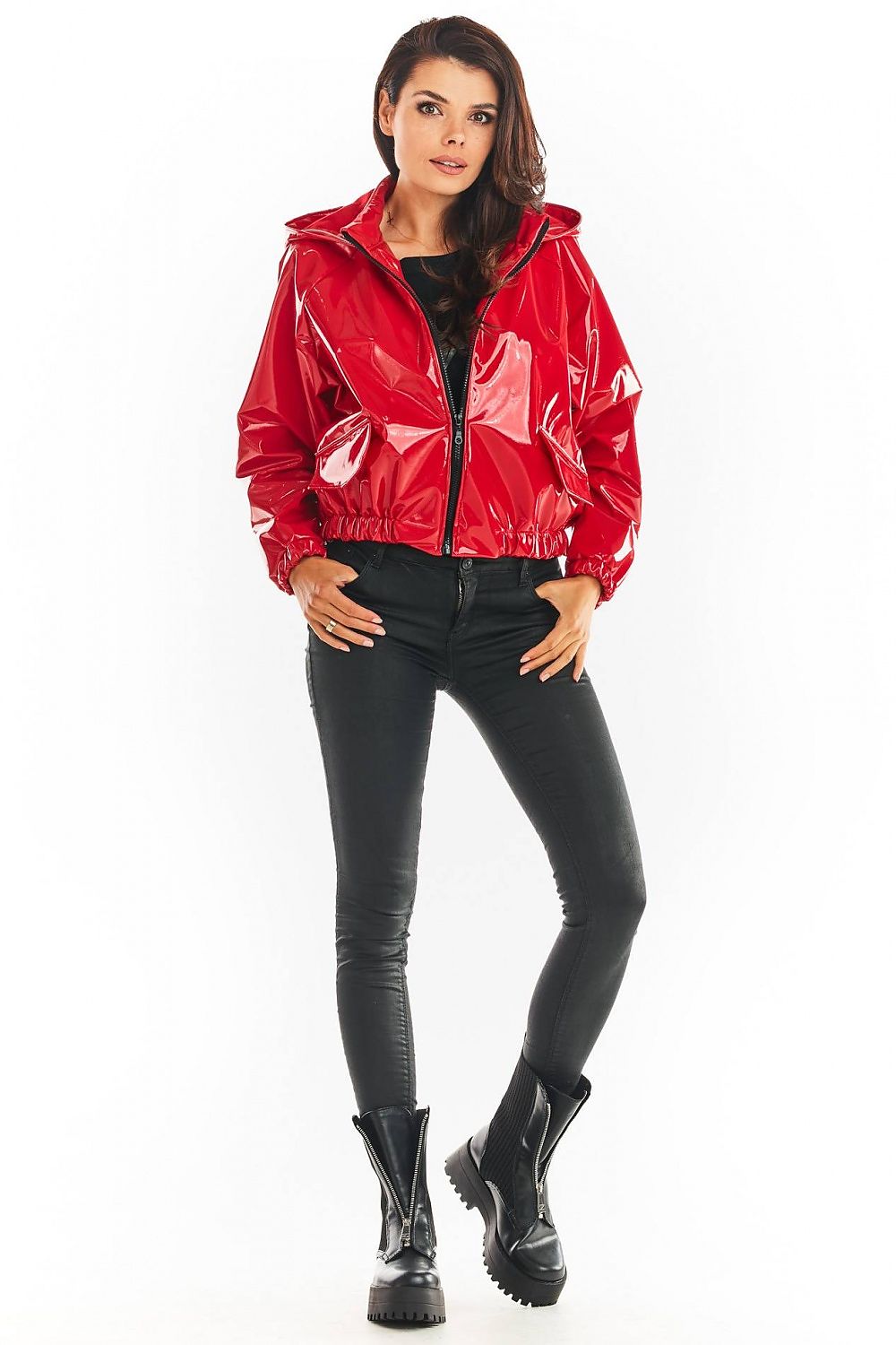 Red Nerivelle short vinyl hooded jacket with ribbed cuffs and zip front, paired with black pants and boots, showcasing street style fashion.