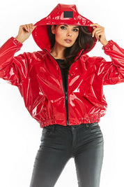 Model wearing red Nerivelle short vinyl hooded jacket with zip front and ribbed cuffs.