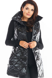 Woman wearing Clarewyn Quilted High-Collar Gilet Vest in shiny black. Fashion layering autumn essential with structured collar.