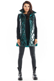 Model wearing Clarewyn Quilted High-Collar Gilet Vest in teal, with tall structured collar and button closure for a stylish autumn look.