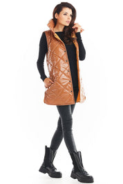 Woman wearing Clarewyn Quilted High-Collar Gilet Vest in brown, styled with black leggings and boots on a white background.