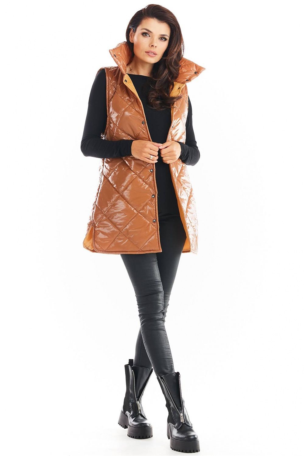 Woman wearing Clarewyn Quilted High-Collar Gilet Vest in brown, featuring a tall collar and button closure, styled with black pants and boots.