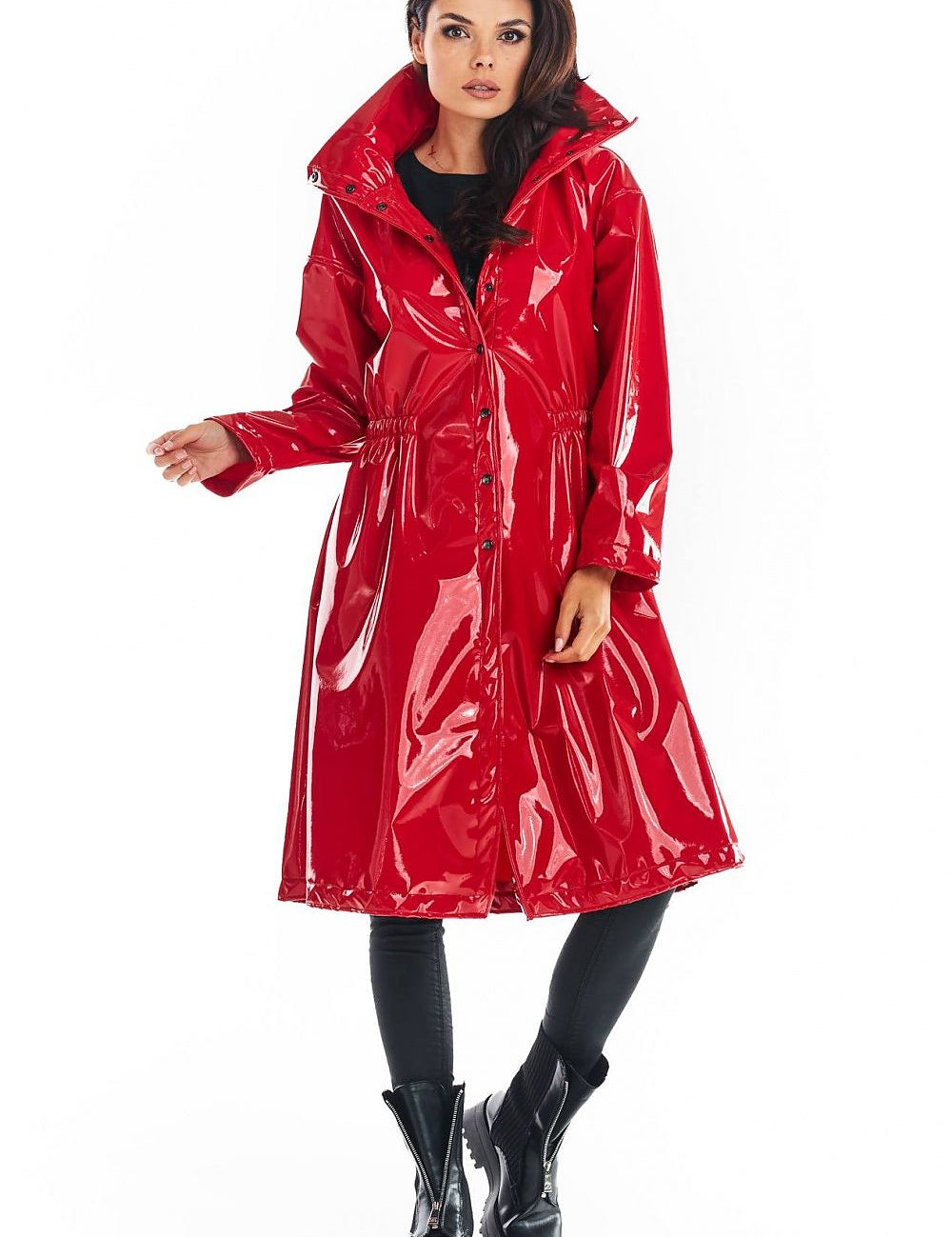 Red Marveena knee-length vinyl raincoat with high collar, flared hem, and adjustable waist for bold style and transitional weather function.