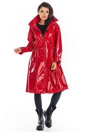Red Marveena knee-length vinyl raincoat with high collar, flared hem, and adjustable waist for bold style and transitional weather function.