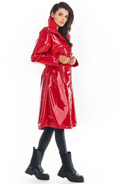 Woman wearing Marveena knee-length red vinyl raincoat with high collar and straight sleeves, featuring a stylish silhouette perfect for trendy weather.