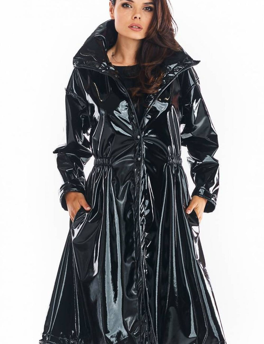 Woman wearing Marveena knee-length black vinyl raincoat with high collar and flared hem.