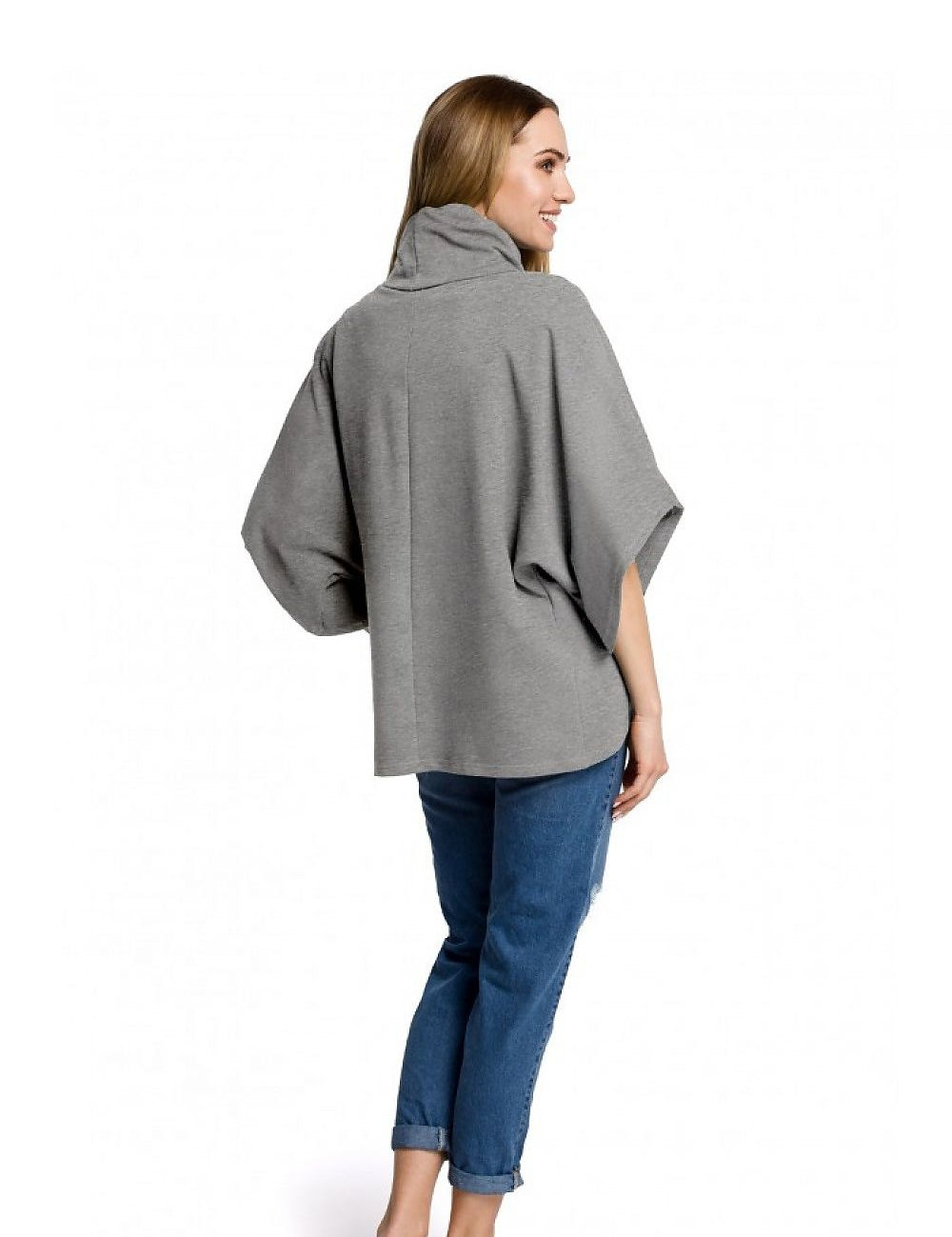 Woman wearing gray Tiraven Knit Turtleneck Blouse with relaxed fit, paired with jeans, showcasing cozy and casual style.