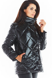Woman wearing a black Zavielle quilted jacket with stand collar, highlighting warmth and versatility. Ideal for transitional weather.