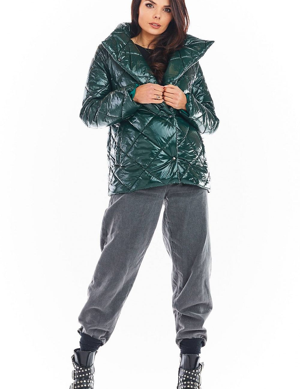 Model wearing Zavielle quilted jacket with stand collar in emerald green, paired with grey pants and studded boots, showcasing stylish warmth.