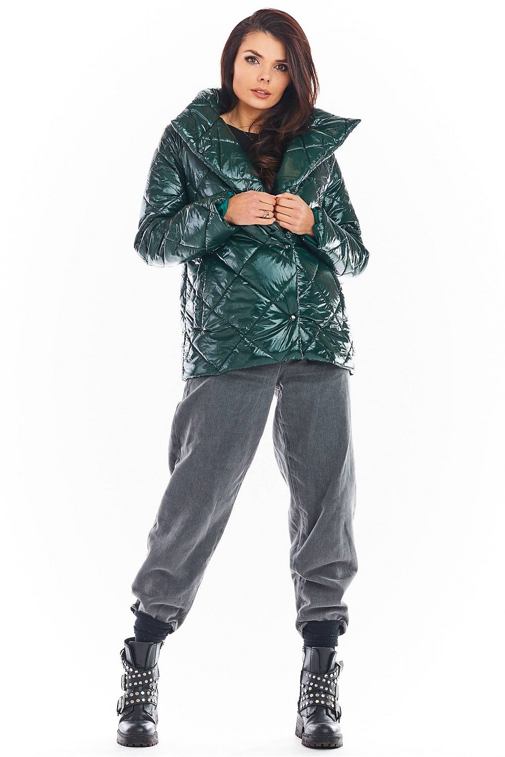 Model wearing Zavielle quilted jacket with stand collar in emerald green, paired with grey pants and studded boots, showcasing stylish warmth.