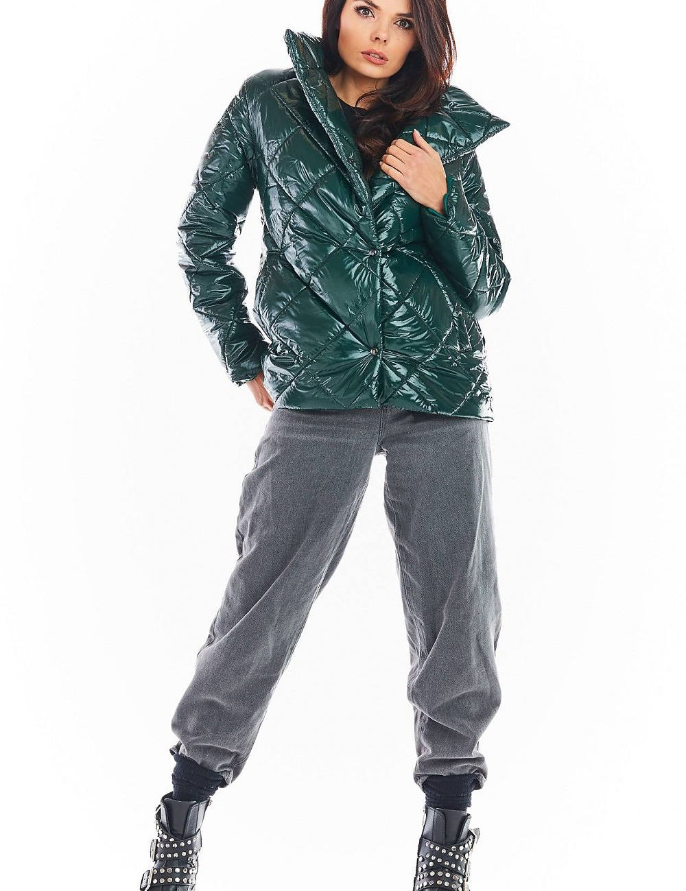 Woman wearing Zavielle quilted jacket with stand collar in green, paired with grey pants and black studded boots, standing confidently.