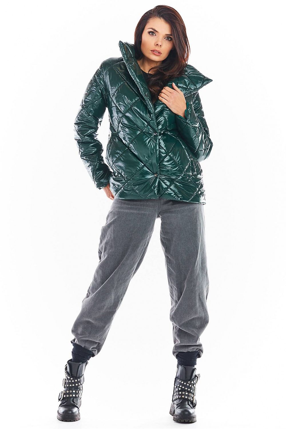 Woman wearing Zavielle quilted jacket with stand collar in green, paired with grey pants and black studded boots, standing confidently.