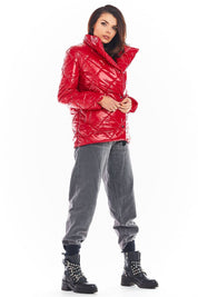 Model wearing red Zavielle quilted jacket with stand collar, paired with grey pants and black boots, highlighting stylish outerwear.