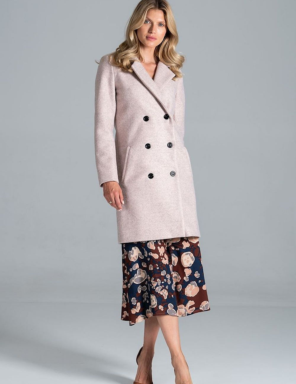 Stylish woman wearing Loryndra belted knee-length autumn coat with six-button front, showcasing timeless tailoring and everyday comfort.