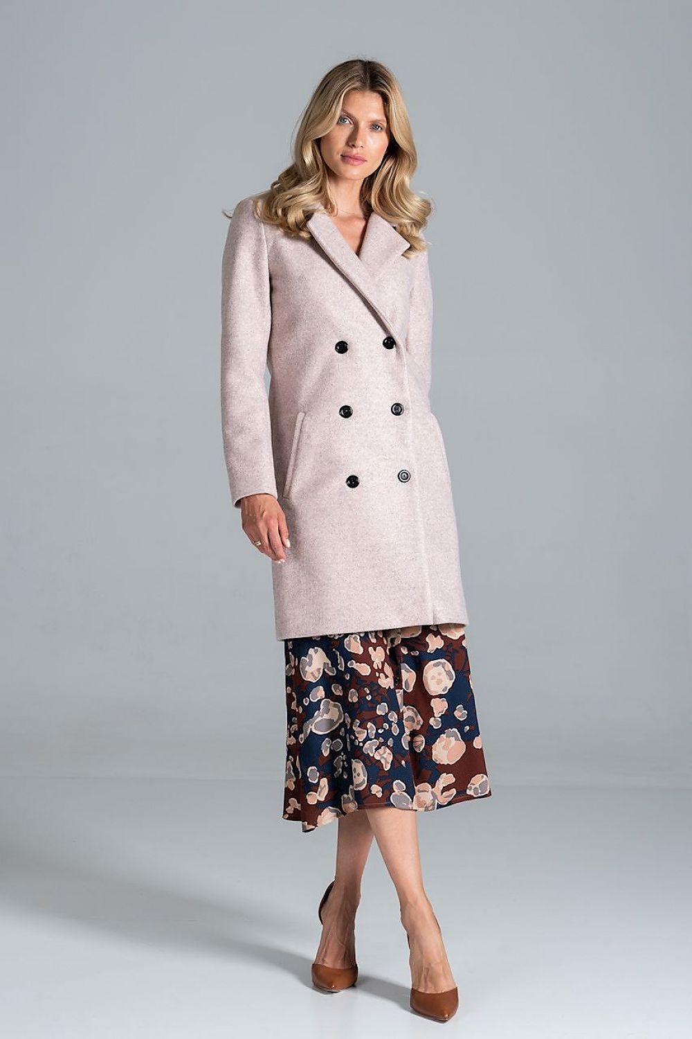 Stylish woman wearing Loryndra belted knee-length autumn coat with six-button front, showcasing timeless tailoring and everyday comfort.